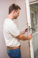 Handyman testing the door handle