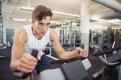 Fit man working out on the exercise bike