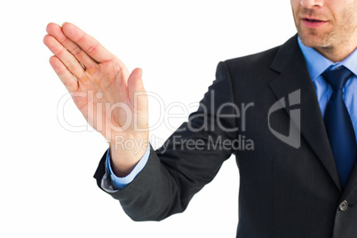 Businessman holding hand out in presentation