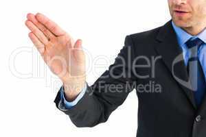 Businessman holding hand out in presentation