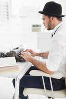 Hipster businessman using a typewriter