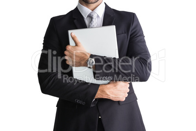 Mid section of businessman holding computer
