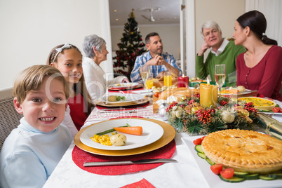 Portrait of brother and sister during christmas dinner