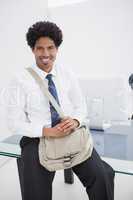 Smiling businessman with shoulder bag