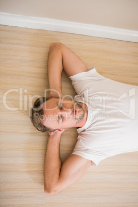 Happy man lying on floor