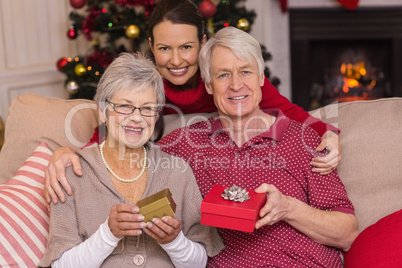 Mother posing with grandparents at christmas