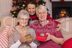 Mother posing with grandparents at christmas