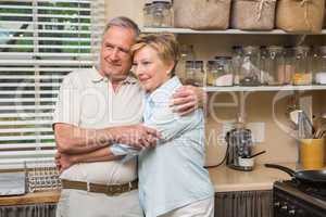 Senior couple hugging and smiling