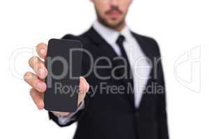 Businessman showing smartphone to camera