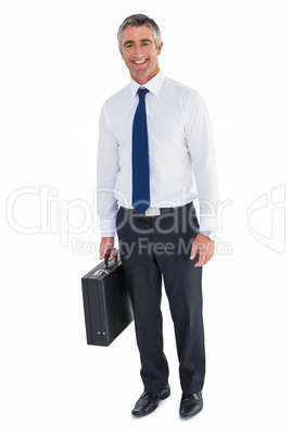 Smiling business man holding briefcase