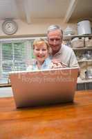 Senior couple using the laptop together