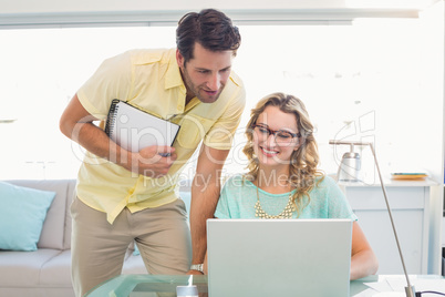 Photo editors working with laptop and notepad