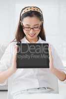 Businesswoman sitting and showing tablet