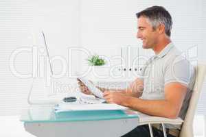 Happy man reading document at desk