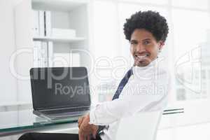 Portrait of a smiling businessman at desk