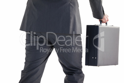 Handsome businessman holding briefcase walking