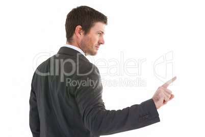 Serious businessman standing and pointing the finger