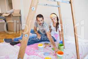 Cute couple about to paint living room