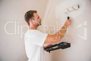 Painter painting the walls white