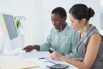 Businesswomen working together at desk