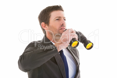 Focused handsome businessman holding binoculars