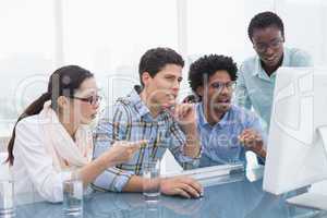 Casual business team working together at desk