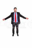 Unsmiling businessman standing with arms outstretched