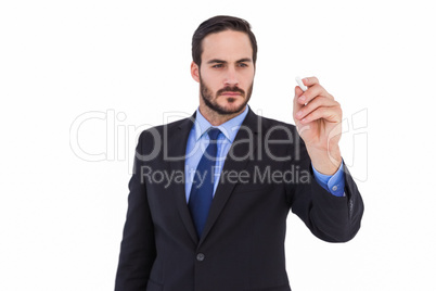 Businessman holding a chalk and writing something