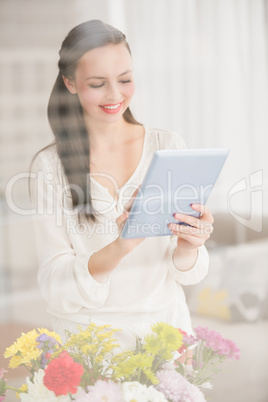 Pretty brunette using her tablet