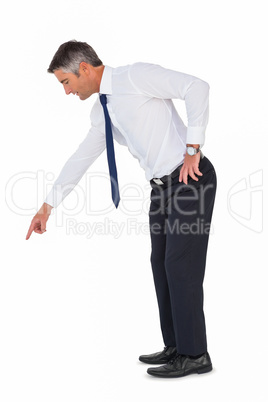 Businessman bending and pointing something down