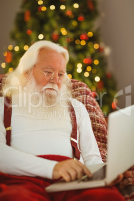 Father christmas typing on laptop