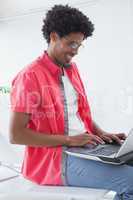 Businessman sitting on his desk using laptop