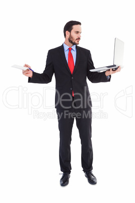 Handsome businessman holding his laptop