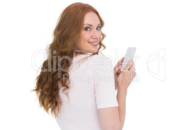 Pretty redhead sending text message