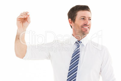 Smiling businessman writing something with white chalk