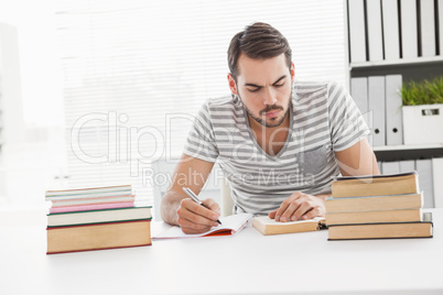 Casual businessman studying at his desk