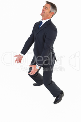 Happy businessman in suit carrying