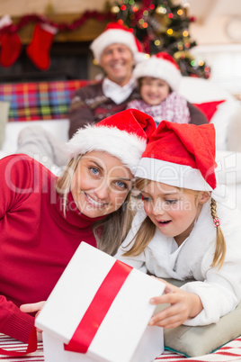 Surprised mother and daughter opening a christmas gift