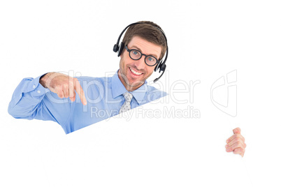 Businessman showing card wearing headset