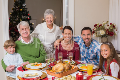 Happy family posing and looking at camera