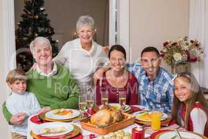 Happy family posing and looking at camera