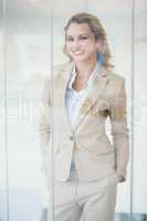 Portrait of smiling businesswoman through the window