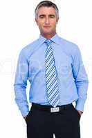 Cheerful businessman with hands in pocket posing