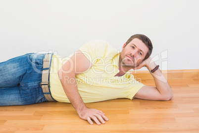 Man lying on floor at home