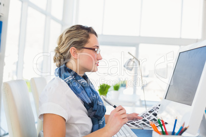 Focused young editor working at her desk