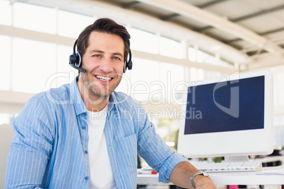 Portrait of a smiling photo editor wearing a headset
