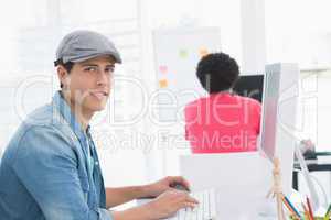 Young creative man working at desk