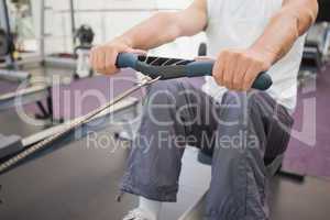 Fit man working out on rowing machine