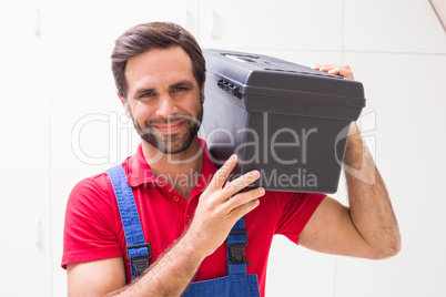 Construction worker holding tool box