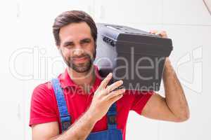 Construction worker holding tool box